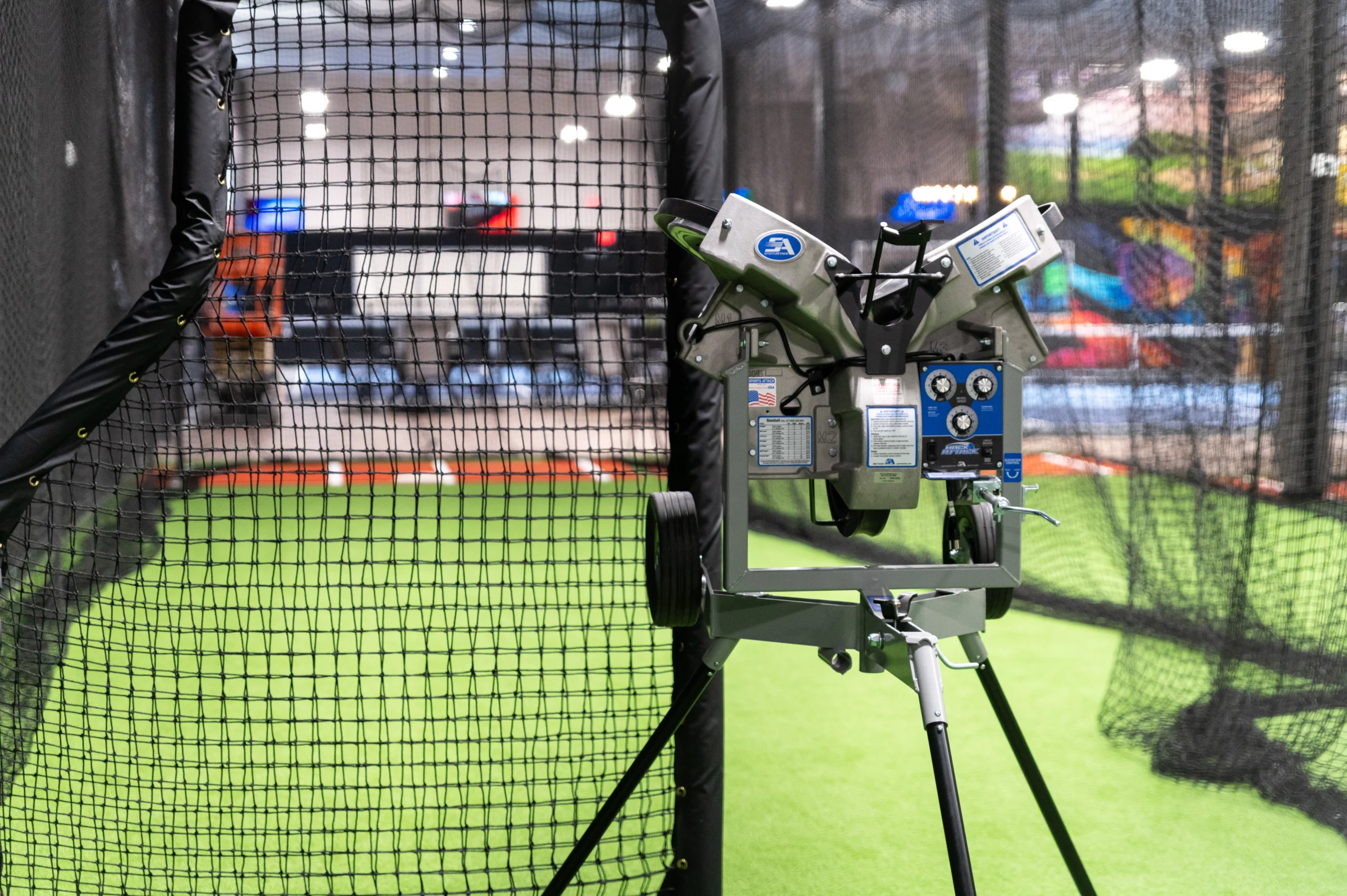 Pitching machine set up inside a batting cage tunnel